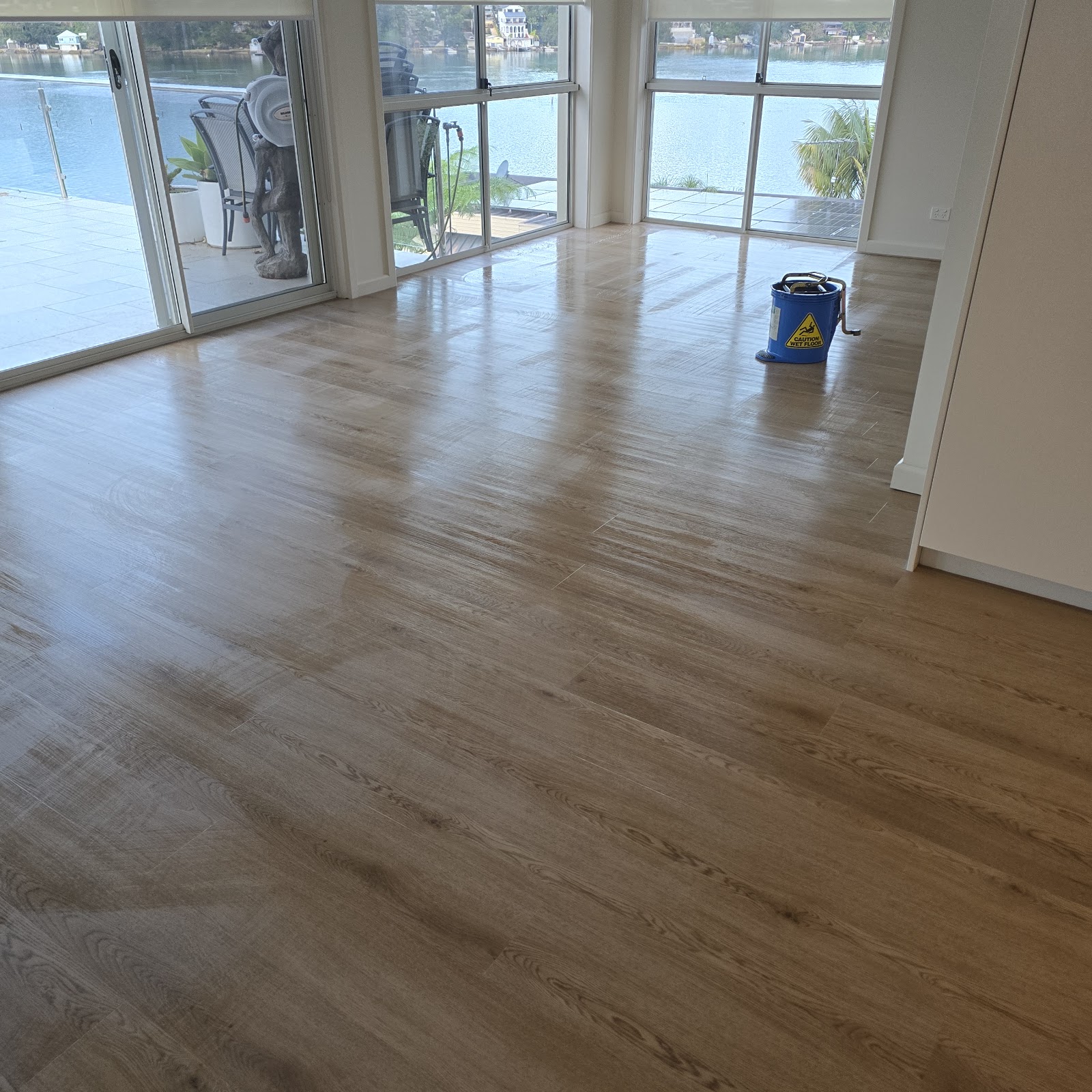 Living room hardwood floor with water view