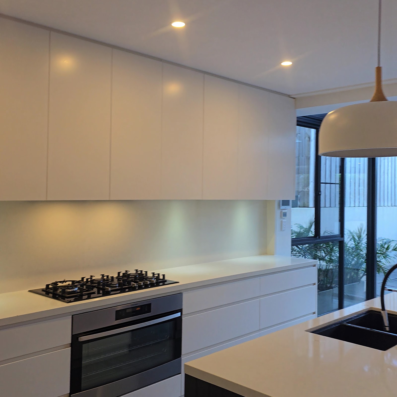 Bright white kitchen with pendant lighting