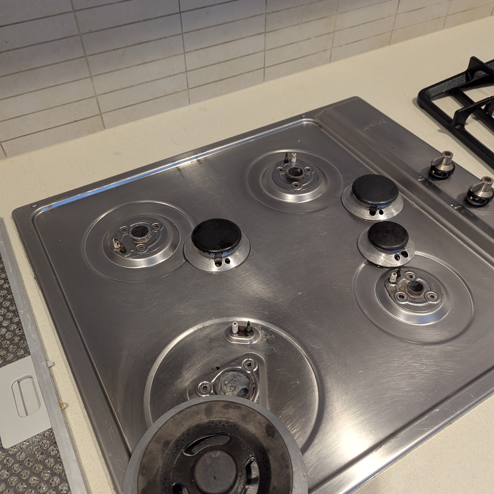 Cooktop burners removed for cleaning